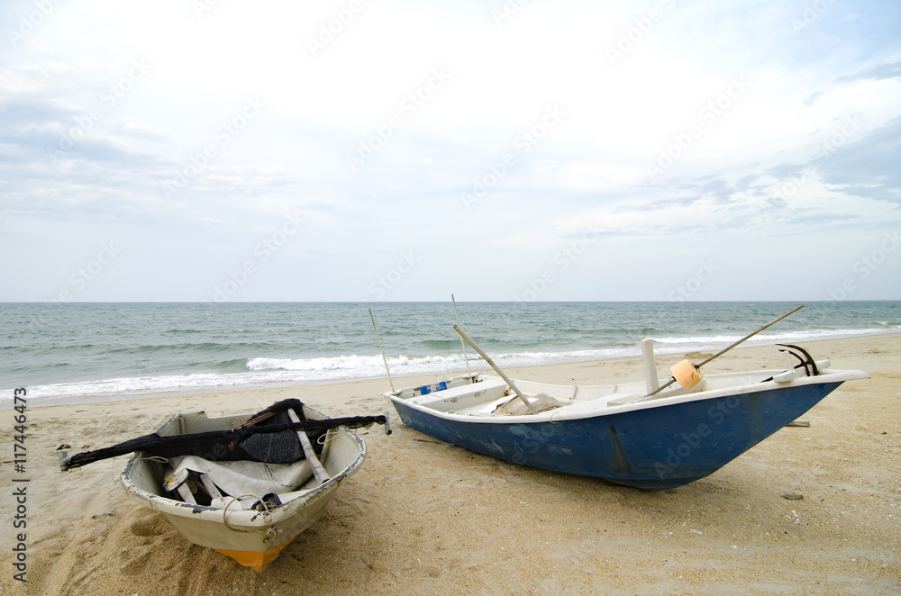 closed up fisherman boat stranded on the sandy beach and cloudy sky.color toning applied.color toning applied closed up fisherman boat stranded on the sandy beach and cloudy sky.color toning applied.color toning applied