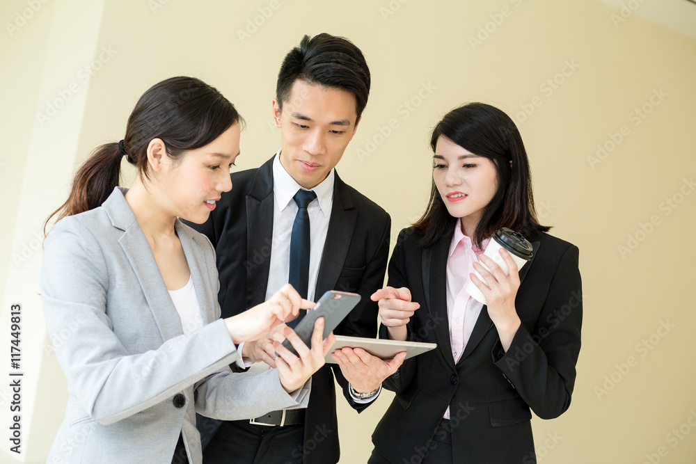 Business team discussing something on tablet computer Business team discussing something on tablet computer