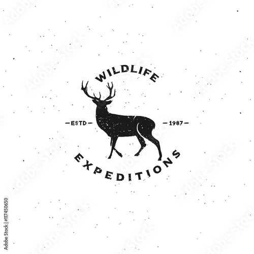 Vintage badge of "wildlife expeditions". Logo for your events. Deer silhouette with antlers. Typography design, Vector.