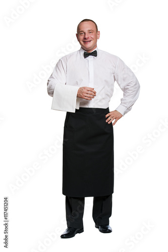 Man waiter standing aprone on isolation background. Smiling. photo