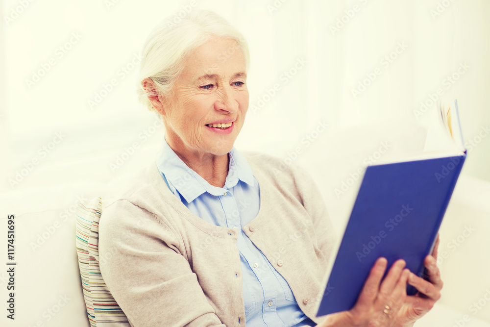 happy smiling senior woman reading book at home happy smiling senior woman reading book at home