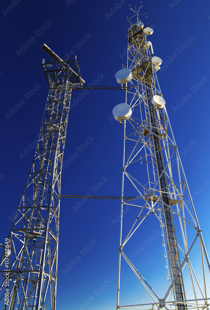 Communication antenna towers on blue sky Communication antenna towers on blue sky