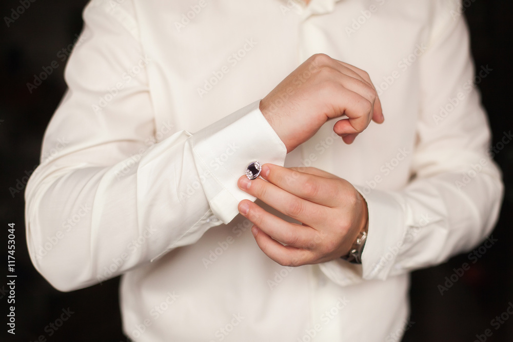 Elegant fashion man fixing his cufflinks, closeup Elegant fashion man fixing his cufflinks, closeup