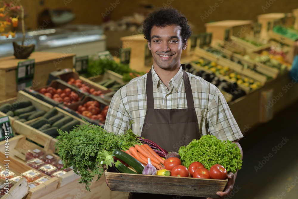 Grocery clerk working in produce aisle of supermarket store Photos | Adobe  Stock