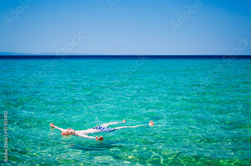 Man lying on sea surface