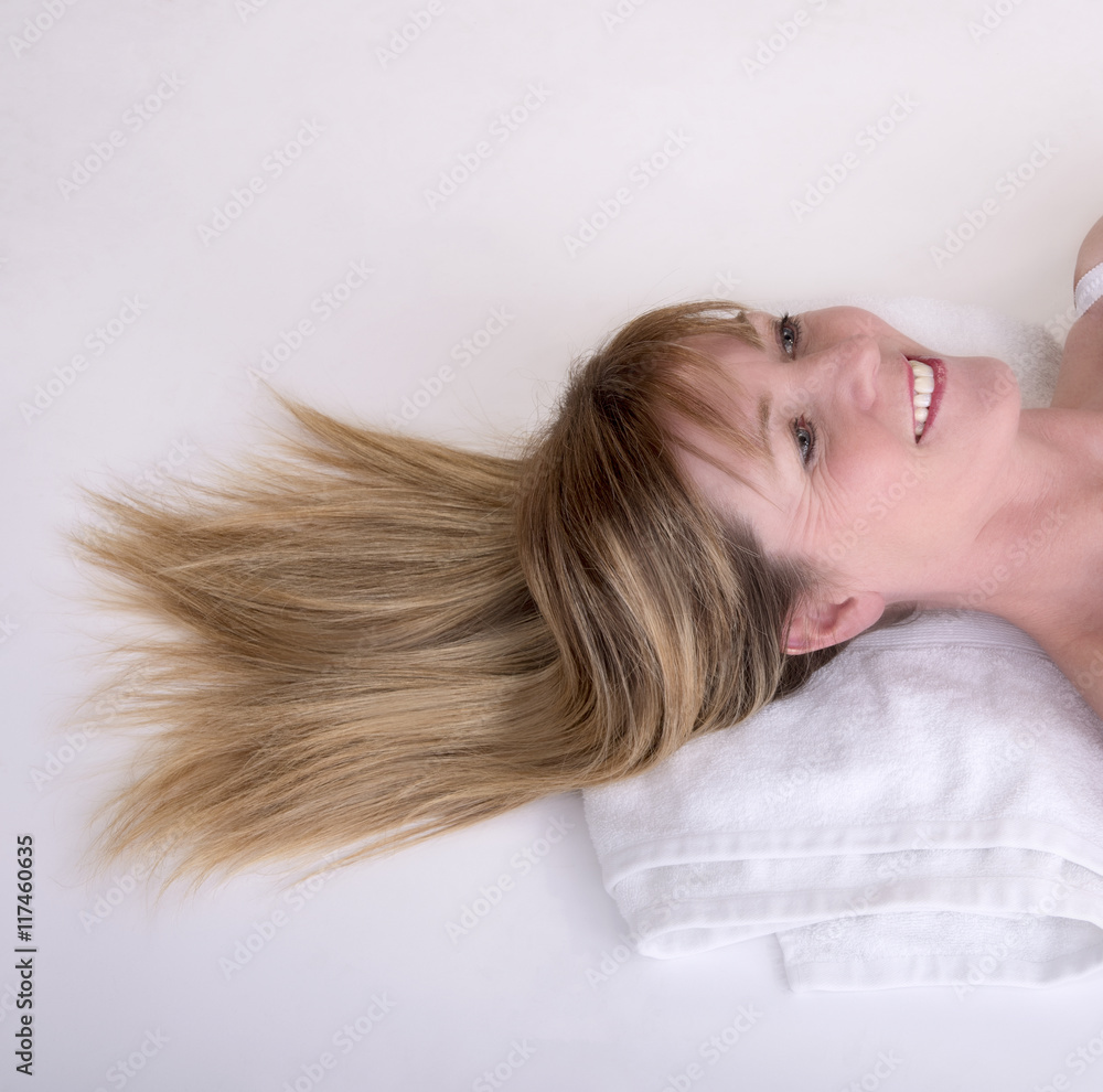 Woman with blond hair laying on a towel Woman with blond hair laying on a towel