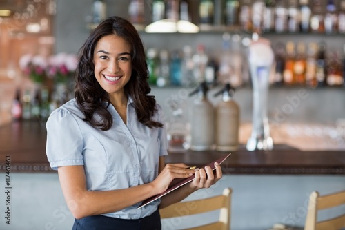 Smiling waitress holding a file