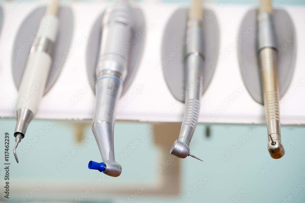 Naklejka premium Stomatological instrument in the dentists clinic. Operation, tooth replacement.