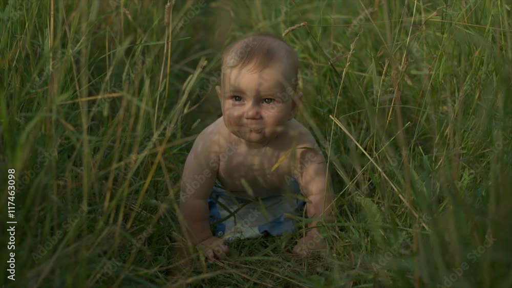 Happy baby in the summer on the nature Happy baby in the summer on the nature