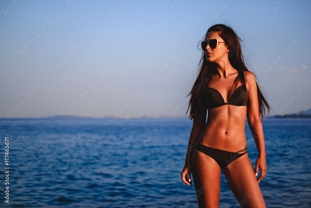 Girl posing with sea in the background Girl posing with sea in the background