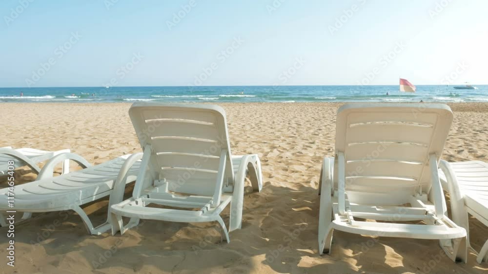 White chairs are placed on the beach for people to relax or sunbath. Beaches make a wonderful vacation spot. One of the most beautiful sceneries. White chairs are placed on the beach for people to relax or sunbath. Beaches make a wonderful vacation spot. One of the most beautiful sceneries.