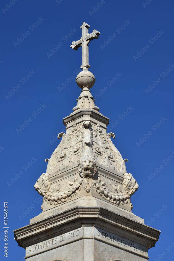Holy cross at the top of monument erected in Tiberina Island (Rome) and made by sculptor Jacometti in 1869