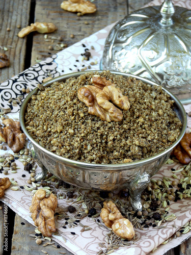 Egyptian spice blend Dukkah nuts, black pepper, coriander, fennel, cumin and other spices - selective focus photo