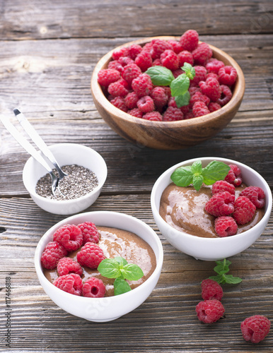 Chocolate Banana Smoothies served fresh juicy ripe raspberries with a sprig of mint in portioned bowls