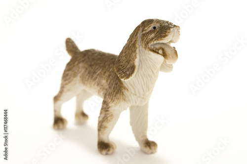 Toy dog made of plastic on a white background.