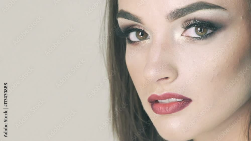 Close up serious look on camera of pretty girl with fine make-up. Slowly Close up serious look on camera of pretty girl with fine make-up. Slowly