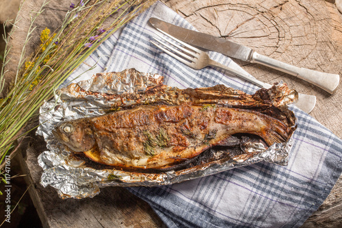 Grilled whole trout on an aluminium foil