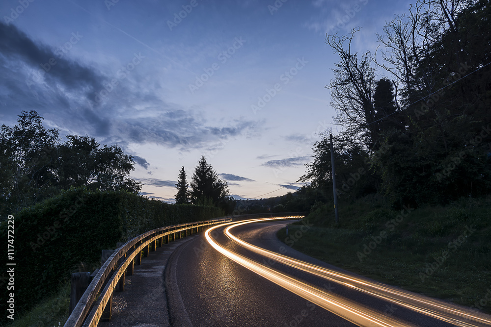 Fototapeta premium Mountain night landscape with light trails of cars