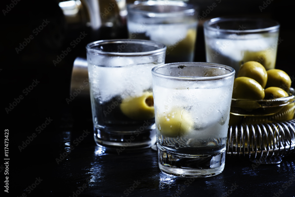 Cocktail with vodka, dry vermouth and green olives in the misted Cocktail with vodka, dry vermouth and green olives in the misted