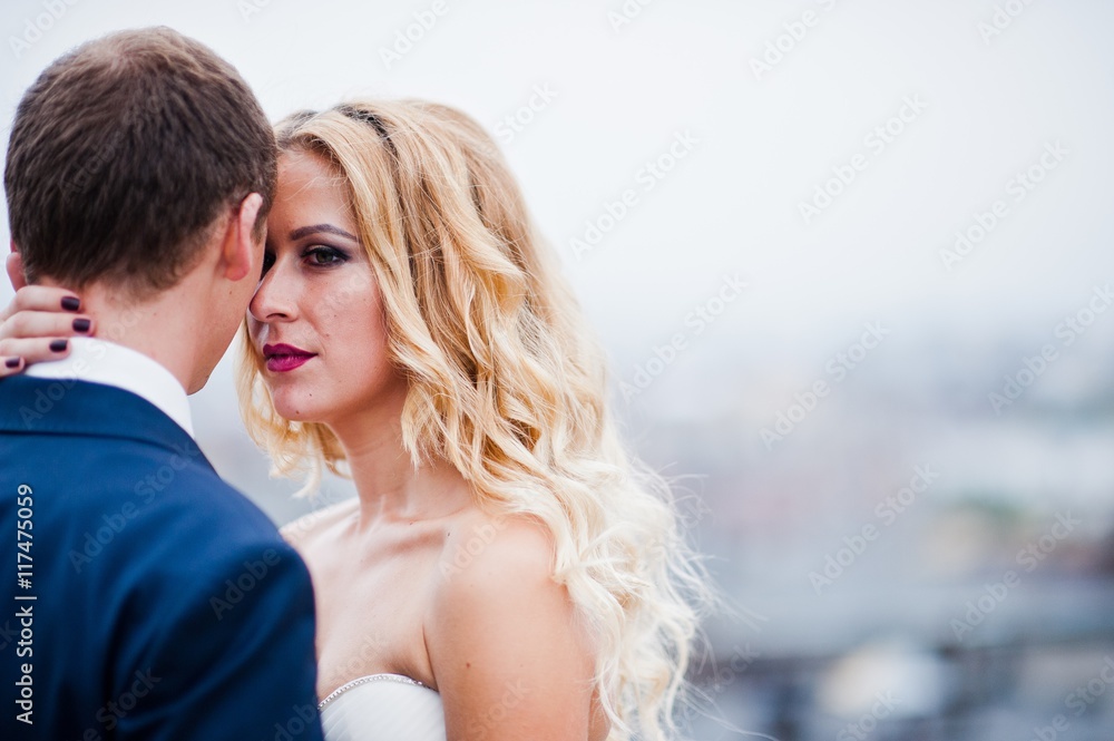 Close up portrait of charming blonde bride with groom Close up portrait of charming blonde bride with groom