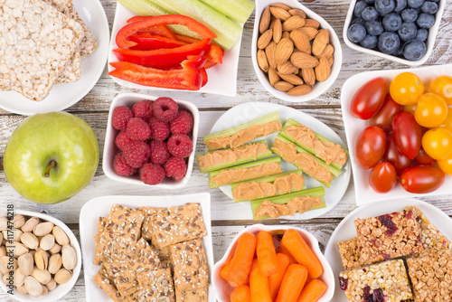 Healthy snacks on wooden table, top view