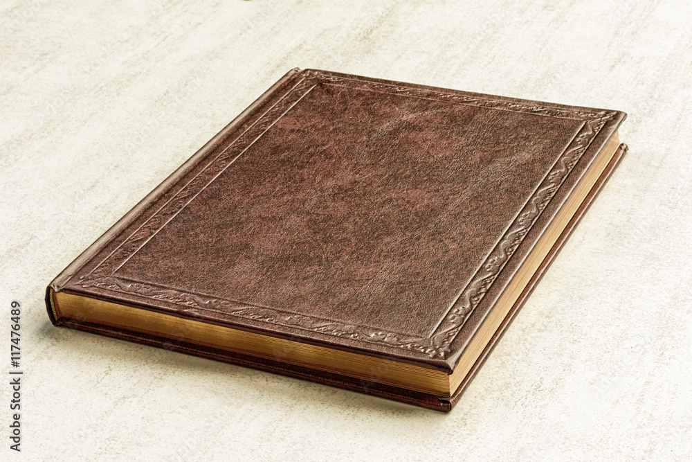the book is brown on a gray background close up the book is brown on a gray background close up