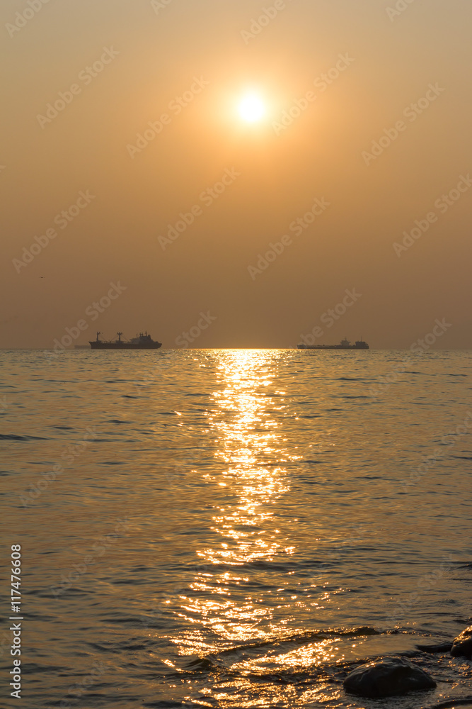 ships at sea on the horizon at sunset ships at sea on the horizon at sunset