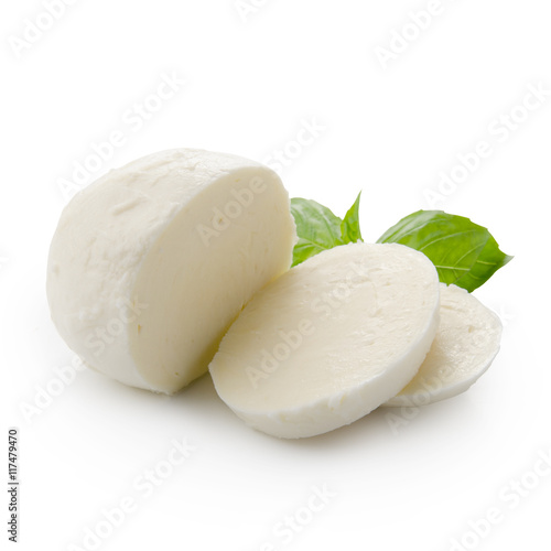 Piece of white mozzarella isolated on white background with clipping path. Decorated with basil. Front view.