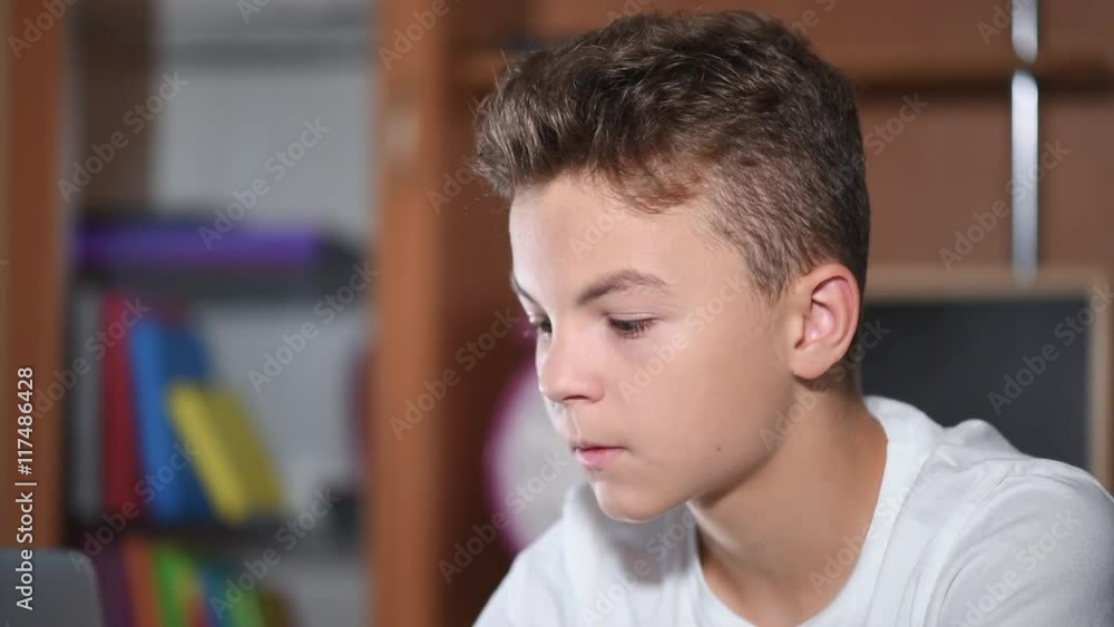 Teen boy working on laptop Teen boy working on laptop