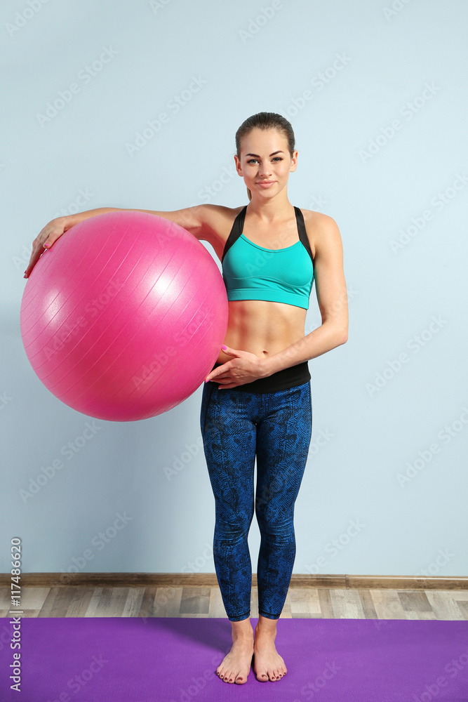 Girl with ball on blue wall background Girl with ball on blue wall background