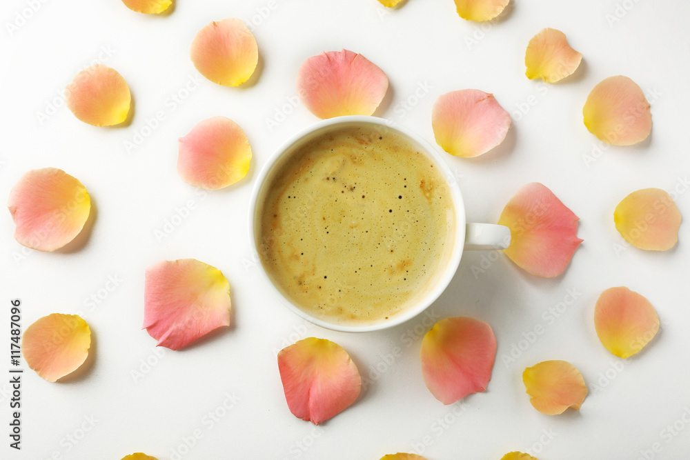 Pink rose petals with cup of coffee on white background Pink rose petals with cup of coffee on white background
