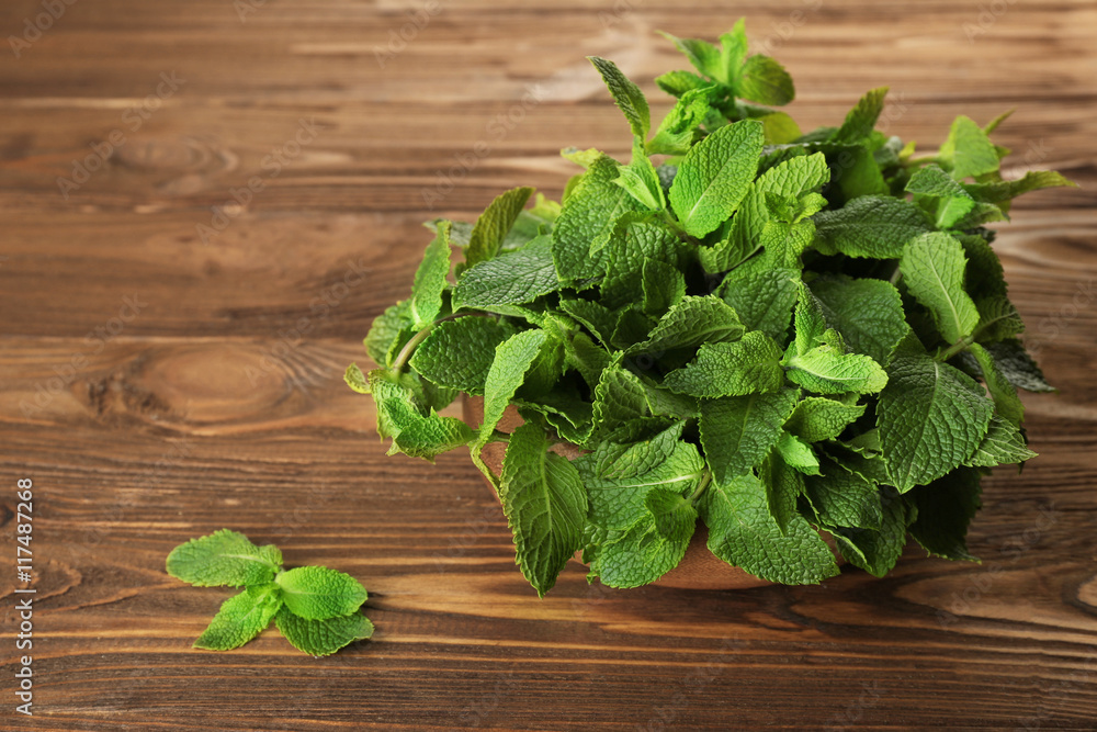 Fresh bunch of mint on wooden table Fresh bunch of mint on wooden table
