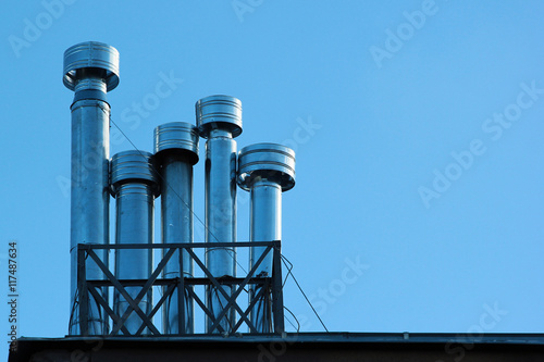 Metal chimneys on a roof photo