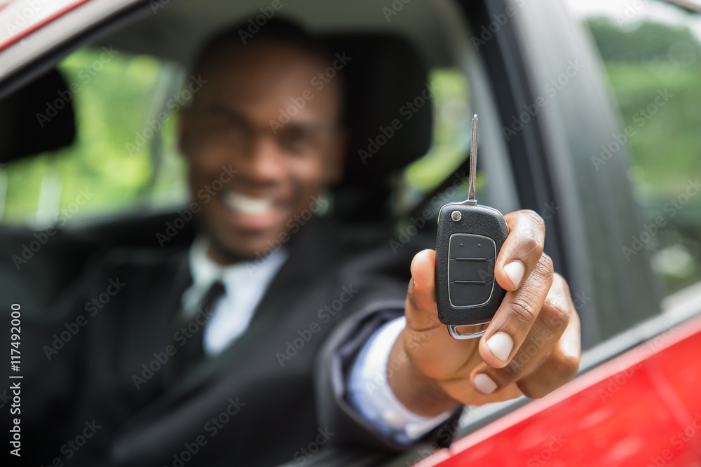 Businessman Sitting In A Car Showing Car Key