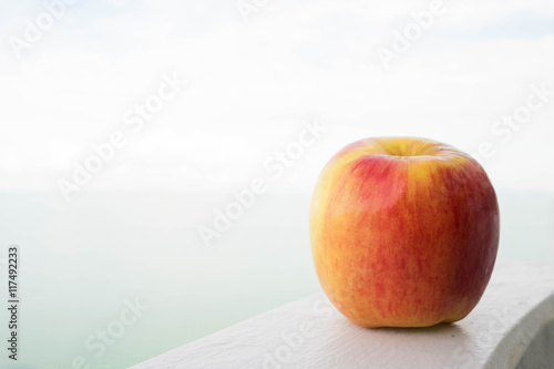 red yellow apple with sea and sky background