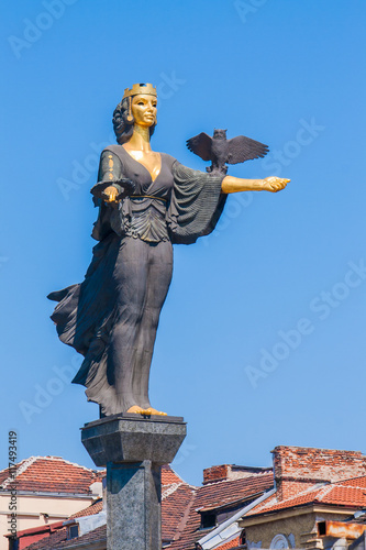 The statue of Saint Sofia in Sofia, Bulgaria rising above the city buildings.