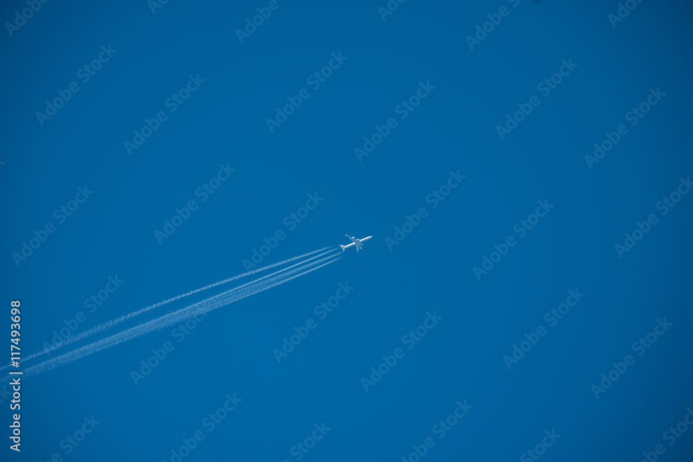 Shot of a jet plane high in the blue sky Shot of a jet plane high in the blue sky