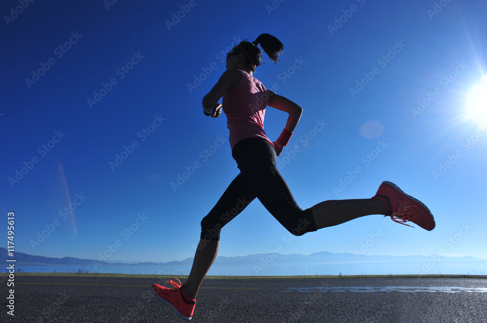 young fitness woman runner running on sunrise seaside trail young fitness woman runner running on sunrise seaside trail