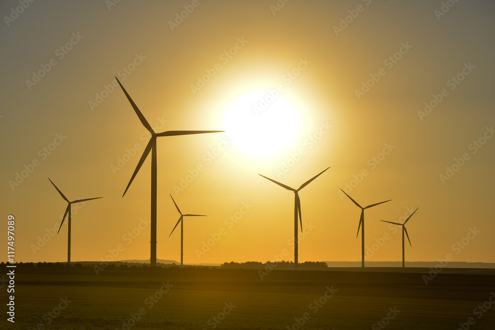 Windwheels and a beautiful sunset seen in rural France Windwheels and a beautiful sunset seen in rural France