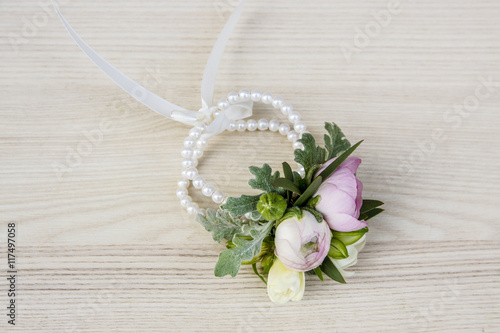 Canvas Print Wrist corsage made of ranunculus and freesia flowers.