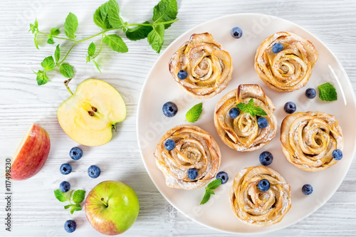 Fotografie apple rose cake or cupcake and blueberry, top view