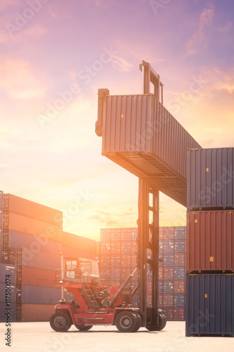 Forklift truck lifting cargo container in shipping yard for transportation import export and logistic industrial concept
