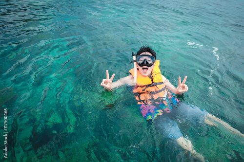Man snorkeling in blue sea