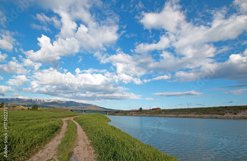 Snake River under cumulus cloud sky in Alpine Wyoming USA