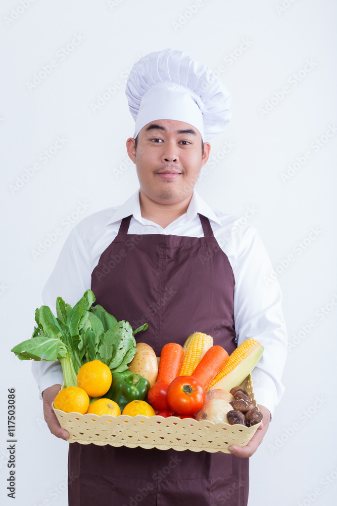 Portrait of a chef holding fruit and vegetable Portrait of a chef holding fruit and vegetable