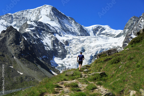 Athlete trail running in the beautiful mountains of Arolla, Switzerland. Sports and healthy lifestyle concept. © sanderstock