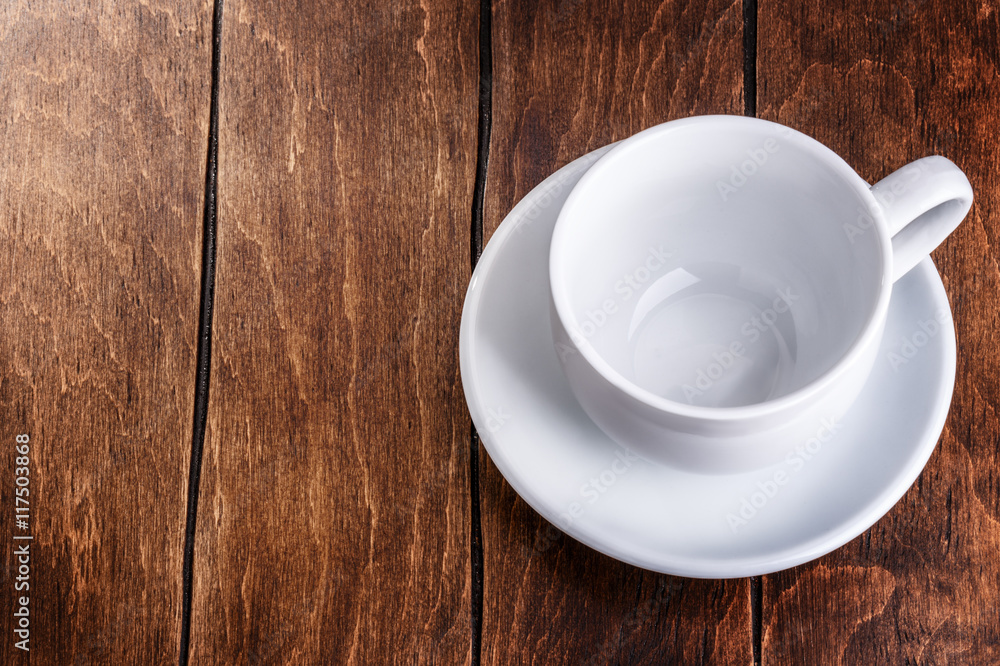 empty white mug on a wooden background empty white mug on a wooden background