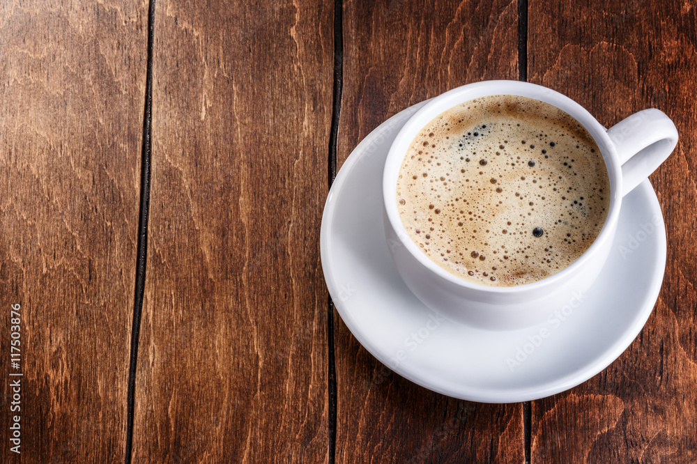 white mug of coffee on a wooden background white mug of coffee on a wooden background