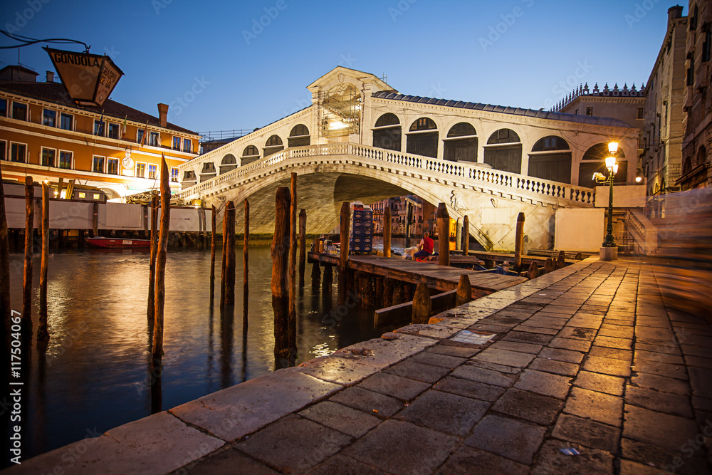 Famous Rialto Bridge during sunrise in Venice.
