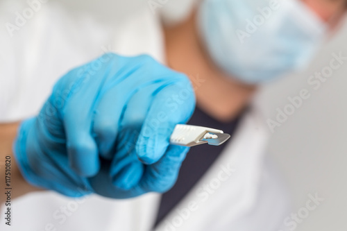 surgeon with a sharp scalpel in his hands